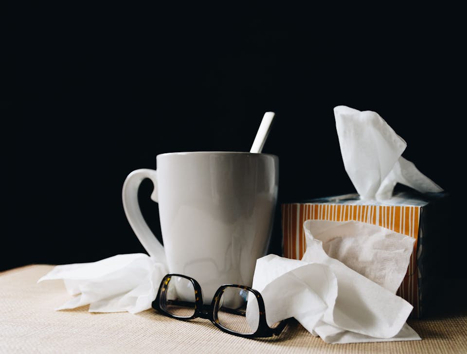 A mug of soup and a box of tissues for an allergy sufferer.